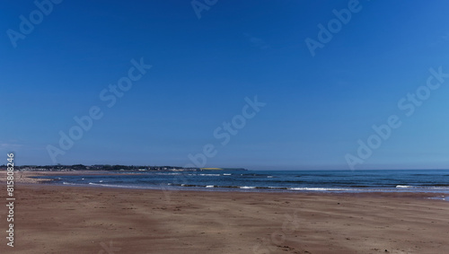 Looking north towards Arbroath in the distance from Elliot Beach  with its sandy Banks exposed at High Tide on a clear day in May.