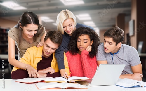 Happy international young students studying together