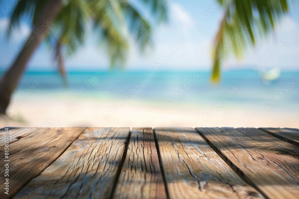 Empty wooden tabletop with bokeh lights on blurred beach and sea