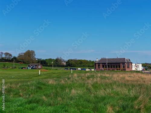 The Clubhouse and Starters Hut of the Artisan Golf Club at Arbroath Golf Links on the East Coast of Scotland on a fine afternoon in May photo