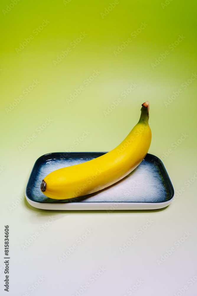 Close-up shot of yellow banana against green background Close-up shot of yellow banana against green background