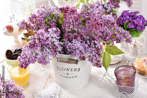 A bunch of fresh purple lilac on the table © teressa
