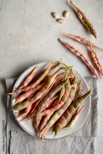 Borlotti beans on delicate gray background. Top view. Copy space.