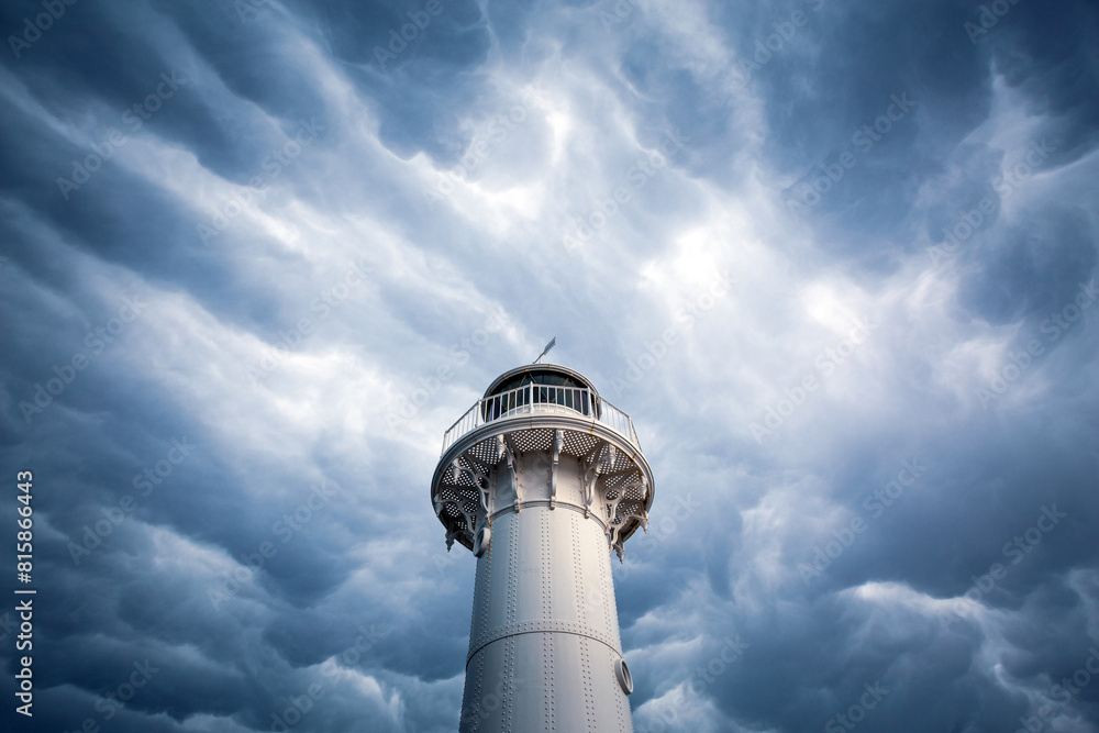 Lighthouse head shrouded my dark moody mammatus clouds