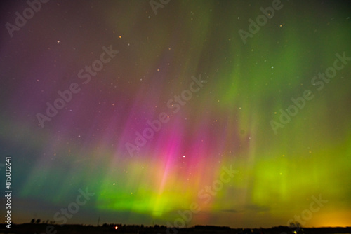 The Aurora Borealis or northern lights creates a incredible display of beautiful multi colored light in the sky above North Dakota.