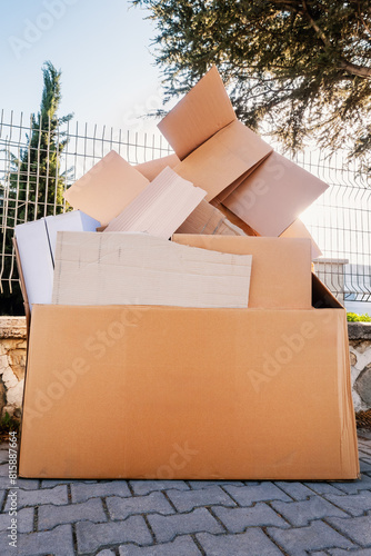 Cardboard boxes dum paper waste, crumpled corrugated cardboard boxes pile, recyclable paper waste on city street © bermuda cat
