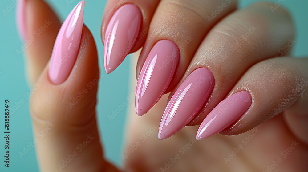 A woman's hand holding pink stiletto nails. A woman's hand holding pink stiletto nails.