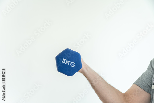 Arm lifting a dumbbell against a plain white background