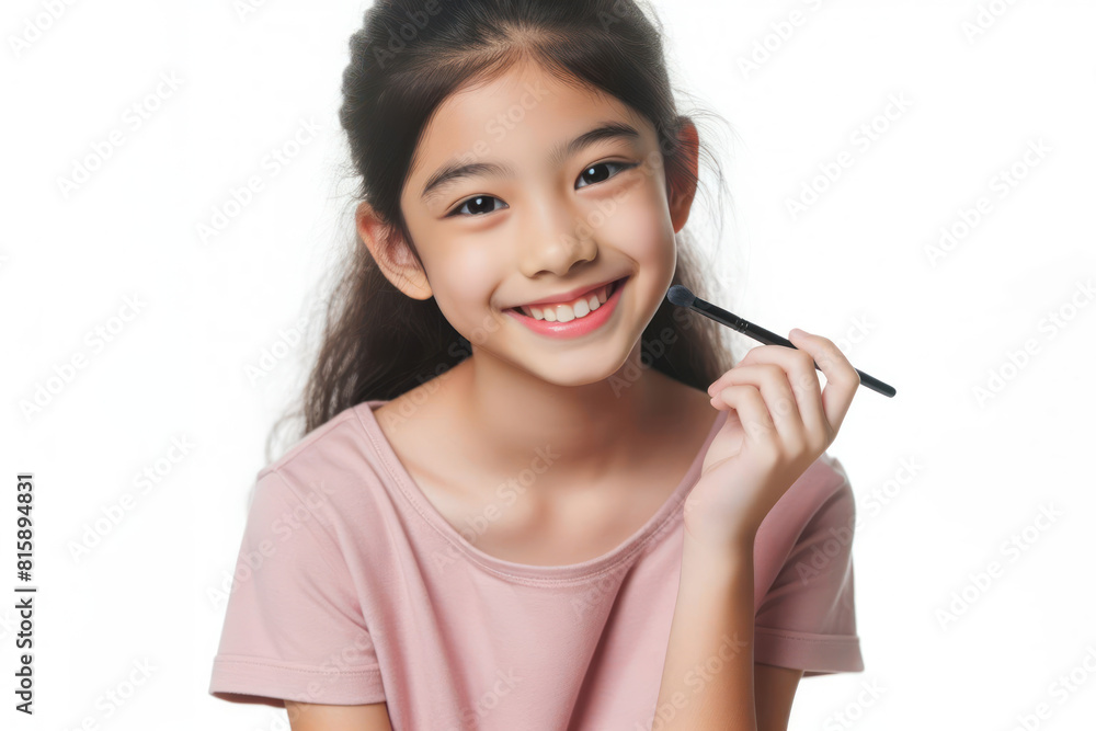 A kid girl is smiling and applying makeup on her face isolated on white background A kid girl is smiling and applying makeup on her face isolated on white background