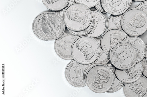 Ukrainian money, exchange coin, white coins denomination of 10 hryvnias in random order. Copy space.