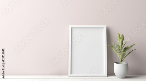 one white picture frame placed on a white table with some plant pot beside it