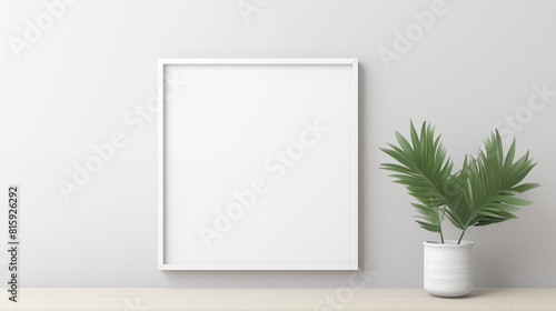 one white picture frame placed on a white table with some plant pot beside it photo