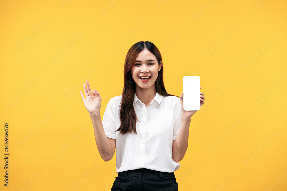 Young asian woman wearing white short sleeve shirt and smiling while holding smartphone with blank screen Young asian woman wearing white short sleeve shirt and smiling while holding smartphone with blank screen
