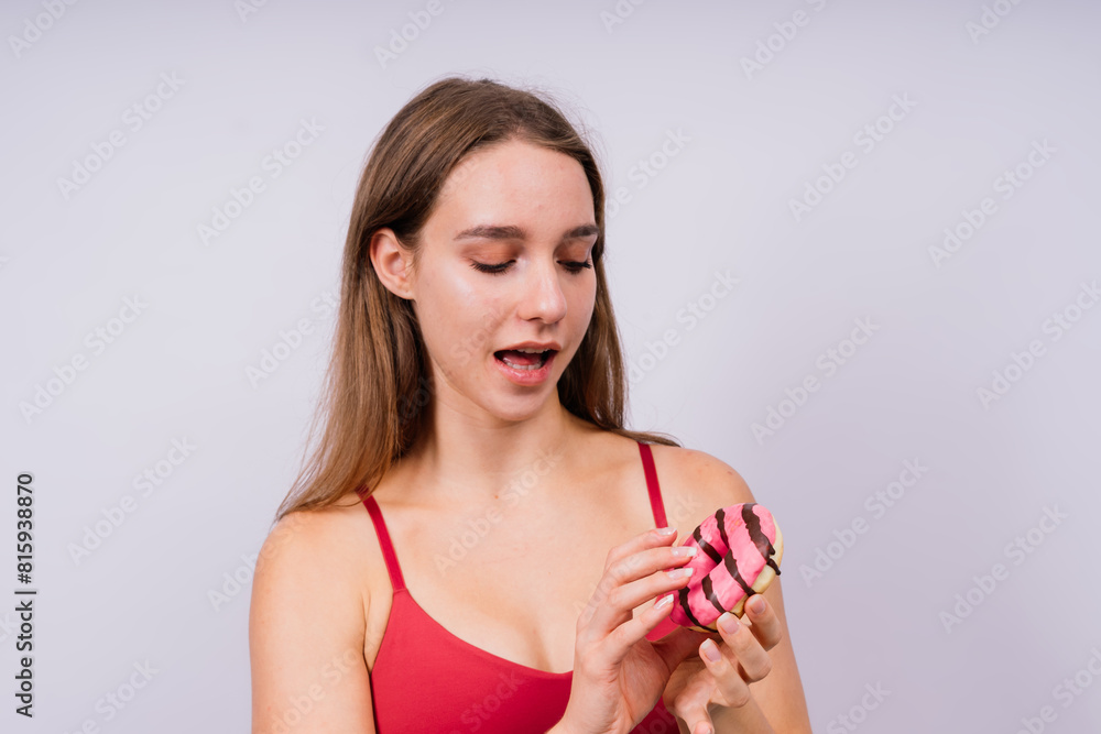 Portrait of beautiful female with chocolate donuts enjoying and looking at camera Portrait of beautiful female with chocolate donuts enjoying and looking at camera