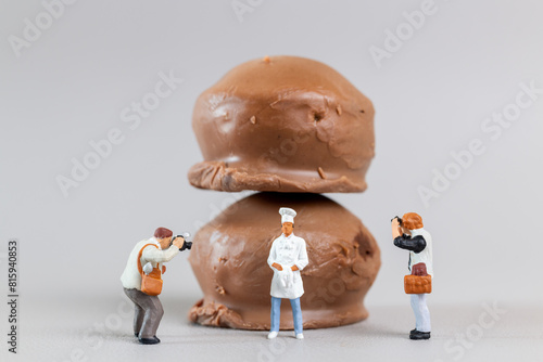 Professional confectioner making tasty chocolate dessert on gray background, World chocolate day concept