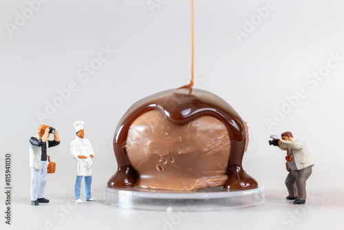 Professional confectioner making tasty chocolate dessert on gray background, World chocolate day concept