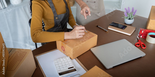 Close up of women preparing packages in a small business office