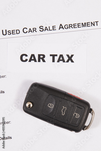Car key, inscription car tax and vehicle sales agreement. Sales, purchases, taxation of automobile. Transportation