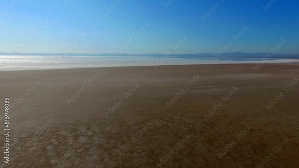 picturesque beach of the Salt Lake of Hoze Sultan, with the camera gently drifting away from the sand. picturesque beach of the Salt Lake of Hoze Sultan, with the camera gently drifting away from the sand.