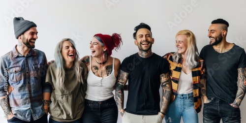 Candid photo of a group of tattoo artists standing against white backdrop wearing appropriate clothes
 photo