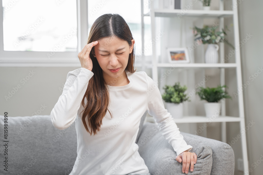 Brain stroke or low blood pressure symptom on people medical concept. Young beautiful woman has a dizziness and motion blurry during standing off sofa at home Brain stroke or low blood pressure symptom on people medical concept. Young beautiful woman has a dizziness and motion blurry during standing off sofa at home