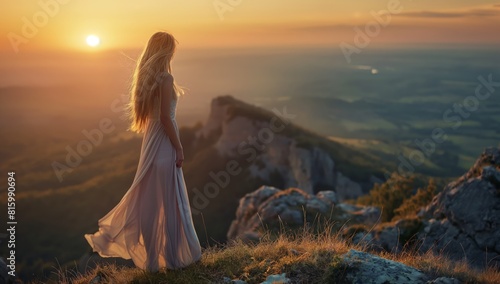 Side view of a blonde woman wearing white dress as she stands outside at dusk on a mountain top