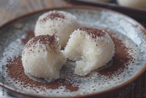 Three balls of cottage cheese with coconut flakes on a plate.