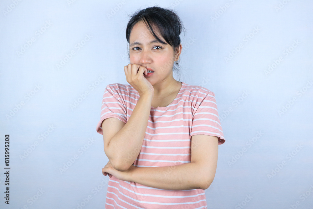worried expression of beautiful asian woman looking at camera while biting finger worried expression of beautiful asian woman looking at camera while biting finger