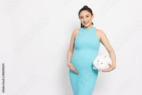 Happy Asian pregnant woman standing and holding big piggy bank isolated on white background, Saving in bank and financial with pregnancy concept