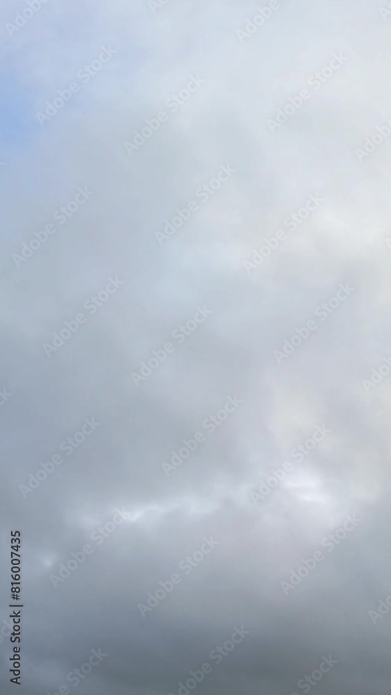 Cloudy Sky Panorama. Grey clouds dominate the sky with small blue breaks, conveying a serene pre-storm atmosphere. Cloudy Sky Panorama. Grey clouds dominate the sky with small blue breaks, conveying a serene pre-storm atmosphere.