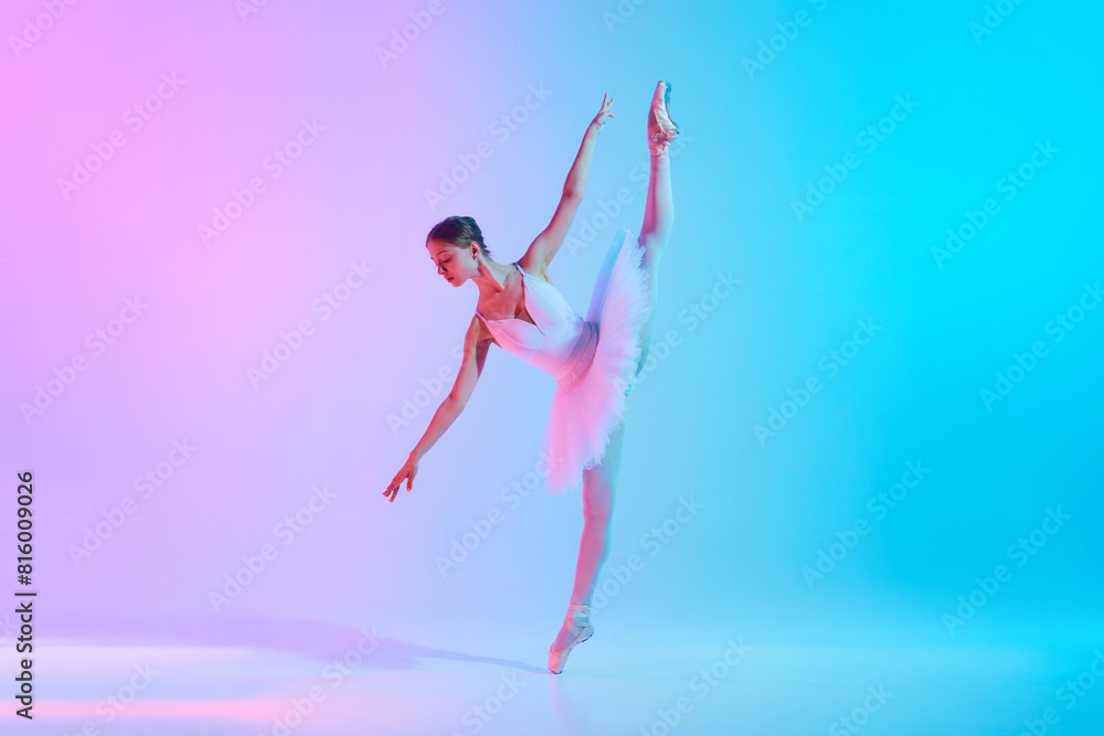 Fototapeta premium Art through motion. Young ballerina in white tutu doing arabesque in motion in neon light against vivid gradient background. Concept of art, movement, classical and modern fusion, beauty and fashion.