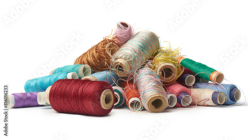 spool of sewing thread used in fabric and textile industry, multi or different colors isolated white background and side view