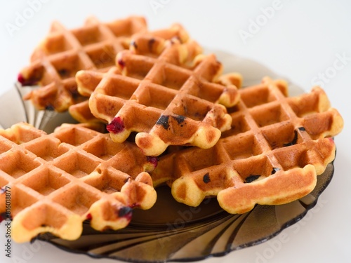 Gluten free homemade waffles on a plate on a white table.
