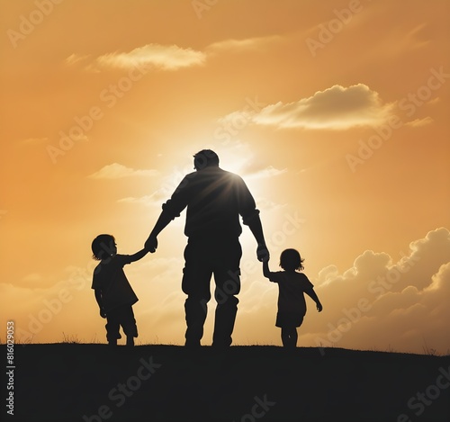 A man holding a baby in a field with the sun behind him