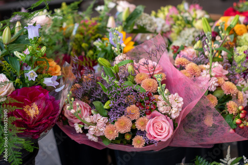 Many different bouquets of flowers on a stand in a flower shop. Presentation. Flower mix background. Beautiful flowers,florist shop bouquets  photo