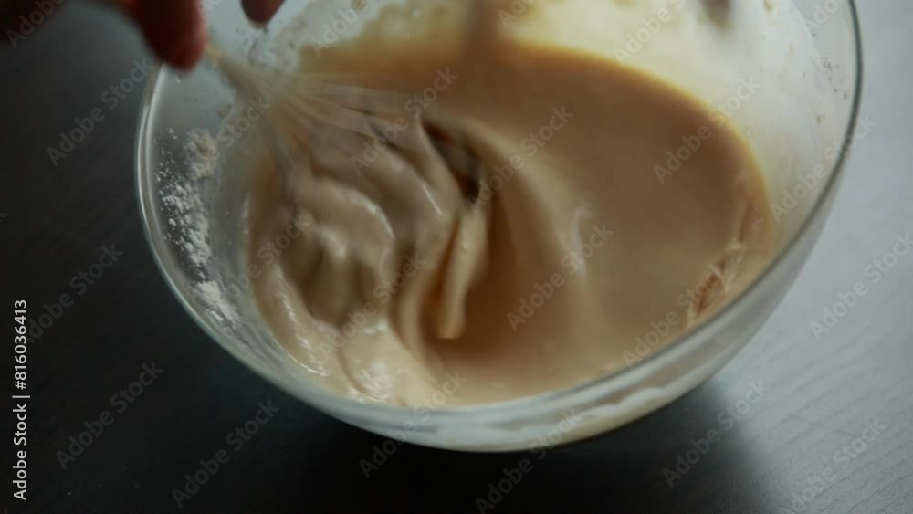 smooth motion of mixing pancake batter in a glass bowl with a whisk in this close-up stock video smooth motion of mixing pancake batter in a glass bowl with a whisk in this close-up stock video