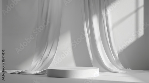 Minimalist white interior with flowing curtains and a circular pedestal bathed in natural light