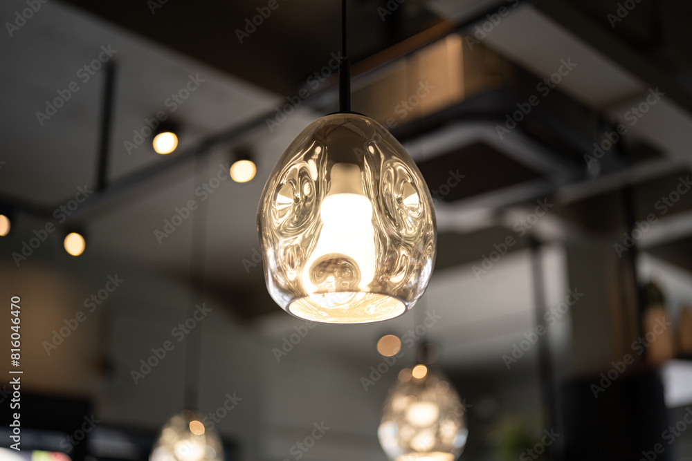 A cozy designed sphere ceiling lighting lamp during glowing in yellow warmlight shade A cozy designed sphere ceiling lighting lamp during glowing in yellow warmlight shade