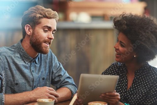 Couple, tablet and happy on date in coffee shop with social media streaming, bonding and online information. Interracial, people and laughing in cafe for funny post update, comic discussion and relax photo