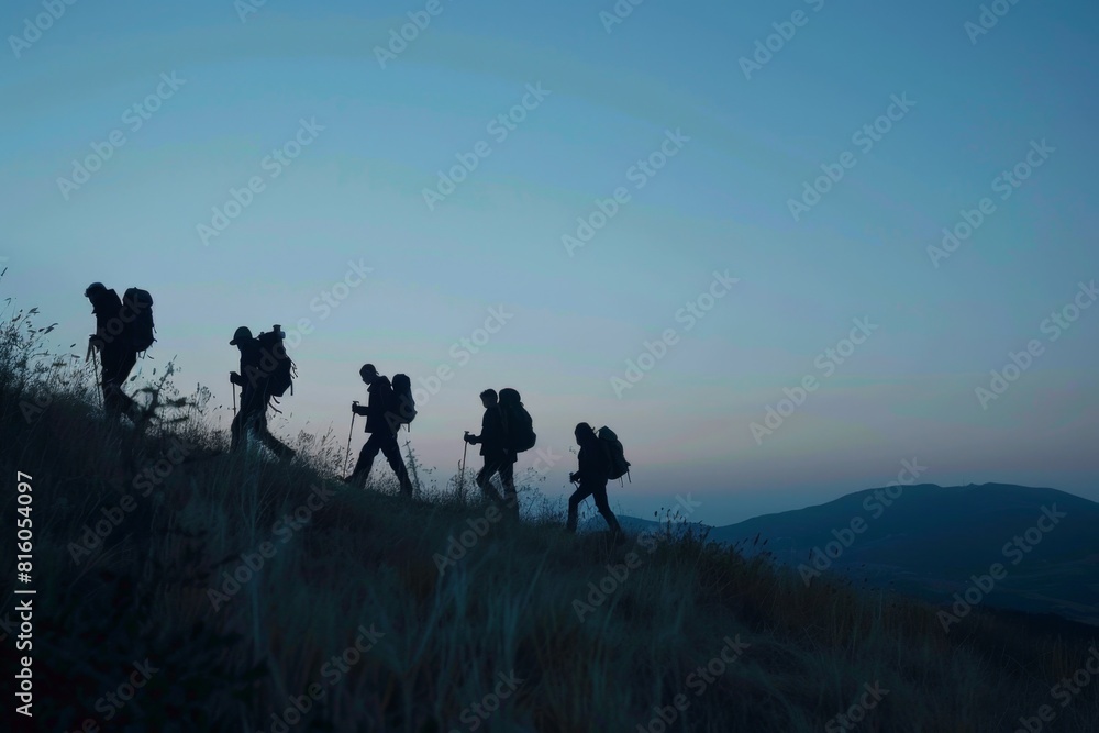 Silhouette of five hikers walking up the hill at dusk Generative AI
