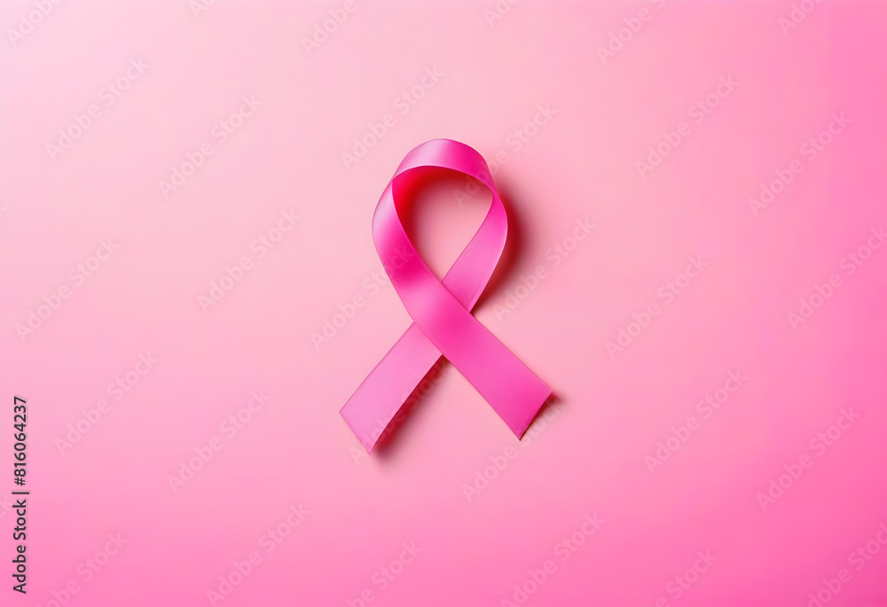 A pink ribbon on a pink background with the words A pink ribbon on a pink background with the words