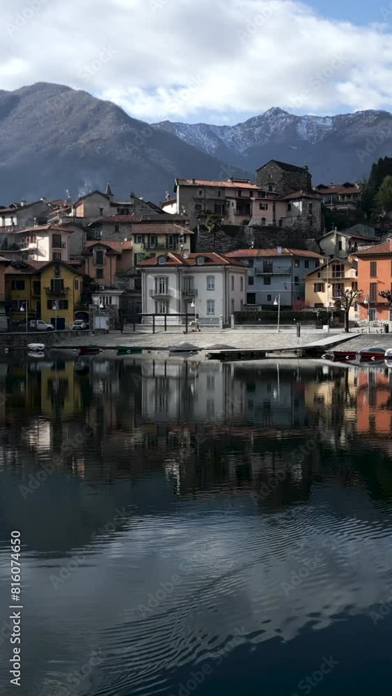 Drone approaches a lakeside village Drone approaches a lakeside village