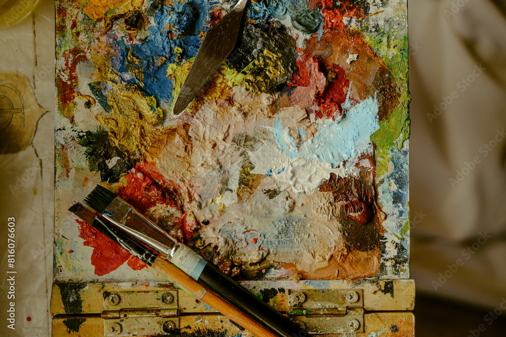 Canvas with paints and brushes