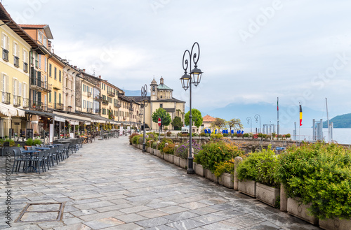 Cannobio, Piedmont, Italy - April 26, 2024: Lakefront of Cannobio with outdoor bars and restaurants, the popular holiday resort on the shore of Lake Maggiore in Piedmont.
