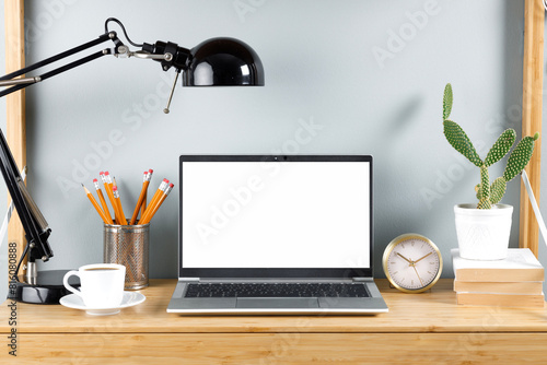 Workspace with blank screen laptop computer