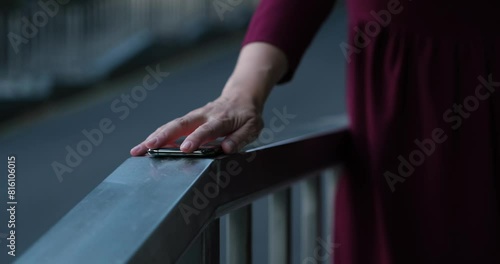 Mobile phone addiction, gambling or waiting for an important phone call concept. Smartphone lying in front of a nervous woman who is going to get it photo