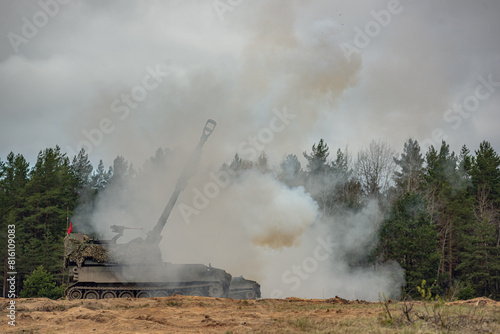firing self propelled howitzer in the smoke