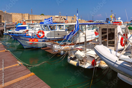 Boats and Greek flags at a marina in Rhodes, Dodecanese islands, Greece