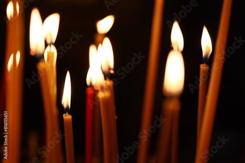 A bunch of candles are lit in a dark room. Can be used for spooky or romantic themes