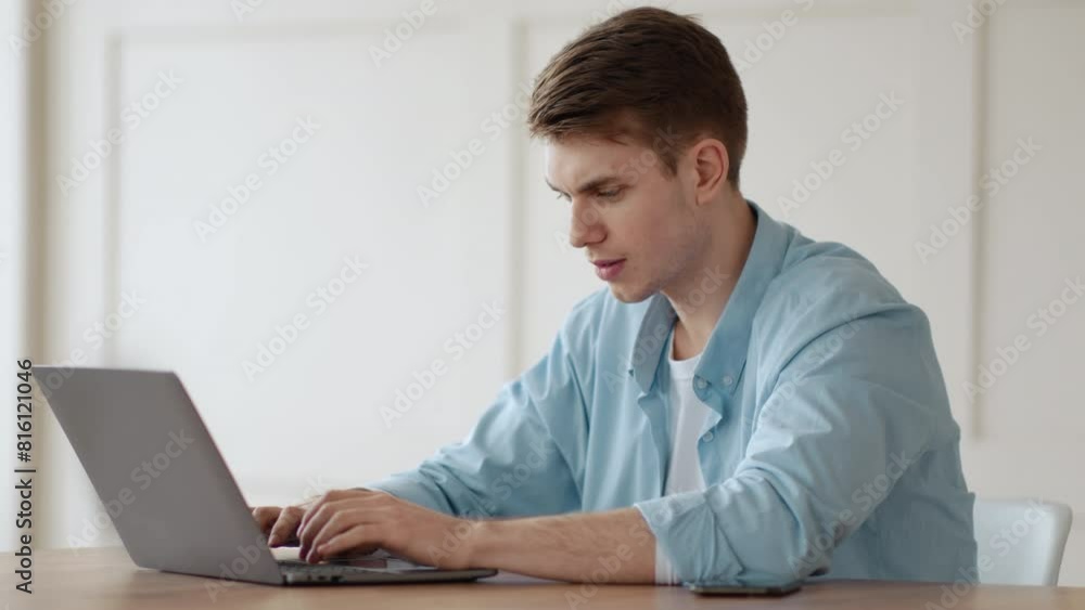 Computer problems. Furious guy screaming at laptop with software error at home Computer problems. Furious guy screaming at laptop with software error at home